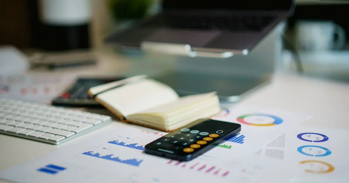 Business owner reviewing a financial report and payment records at a desk to track ACH return codes