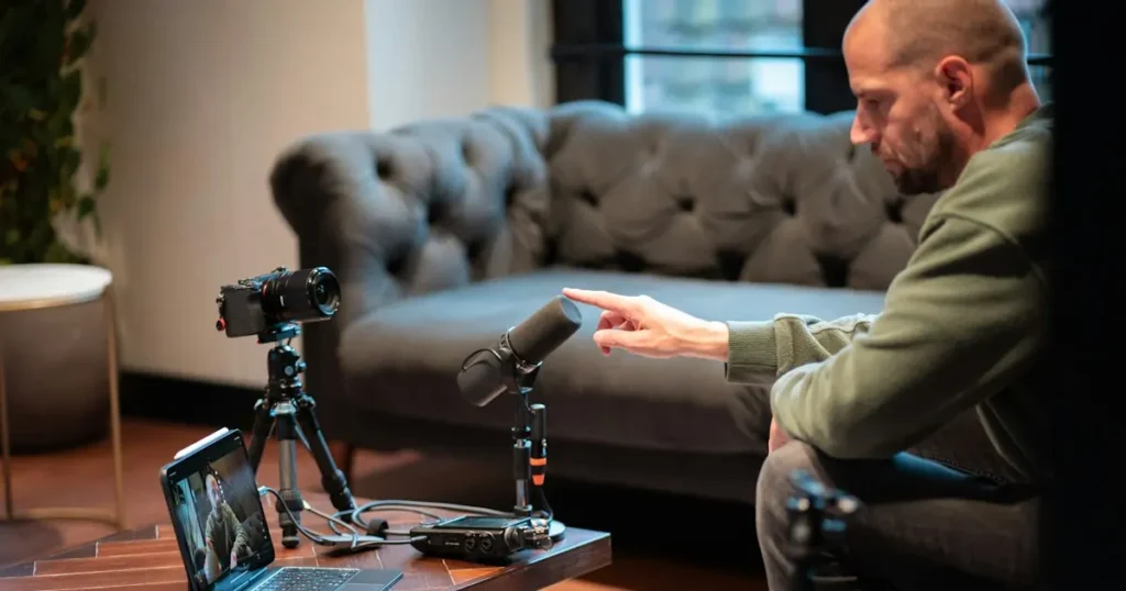 Creator recording video content in a studio, one step in learning how to sell digital products such as online courses