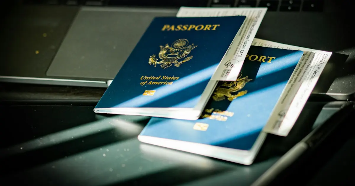 U.S. passports and boarding passes resting on a laptop, illustrating travel agency credit card processing for online bookings