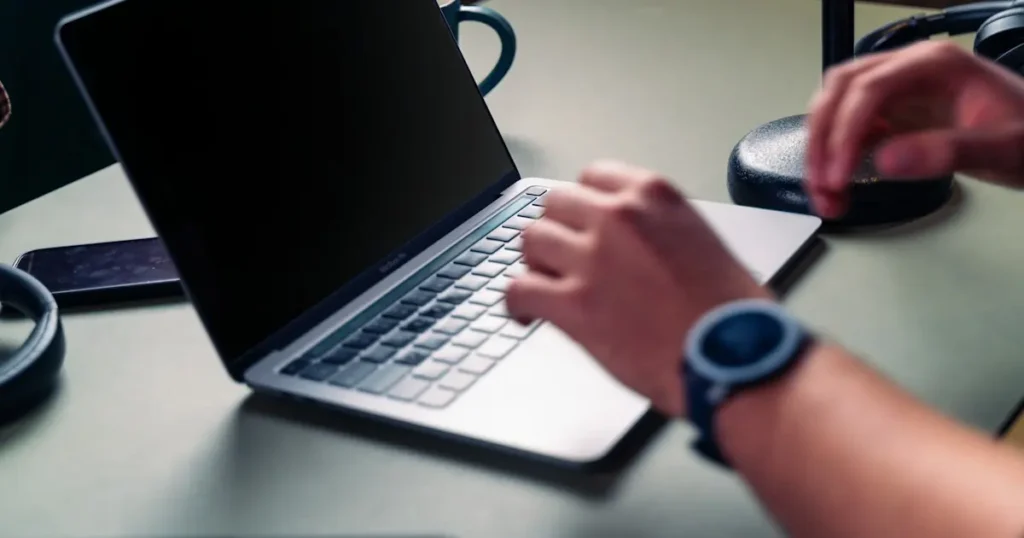 Staff member keying a phone order into a virtual terminal on a laptop, illustrating what is a virtual terminal vs a POS system