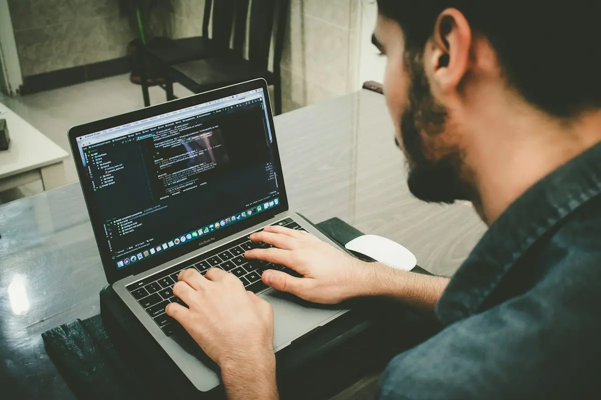 Developer writing payment gateway API integration code on a laptop