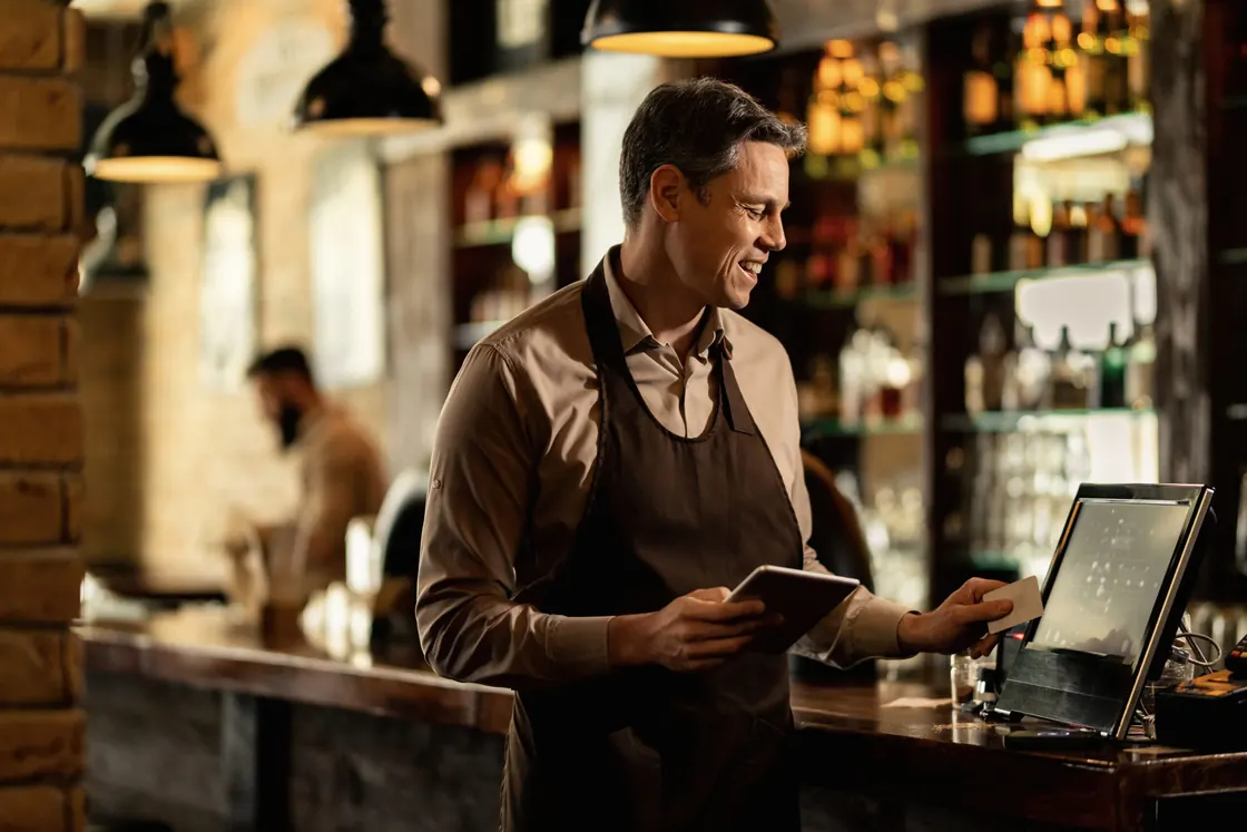 Small business owner processing a customer payment