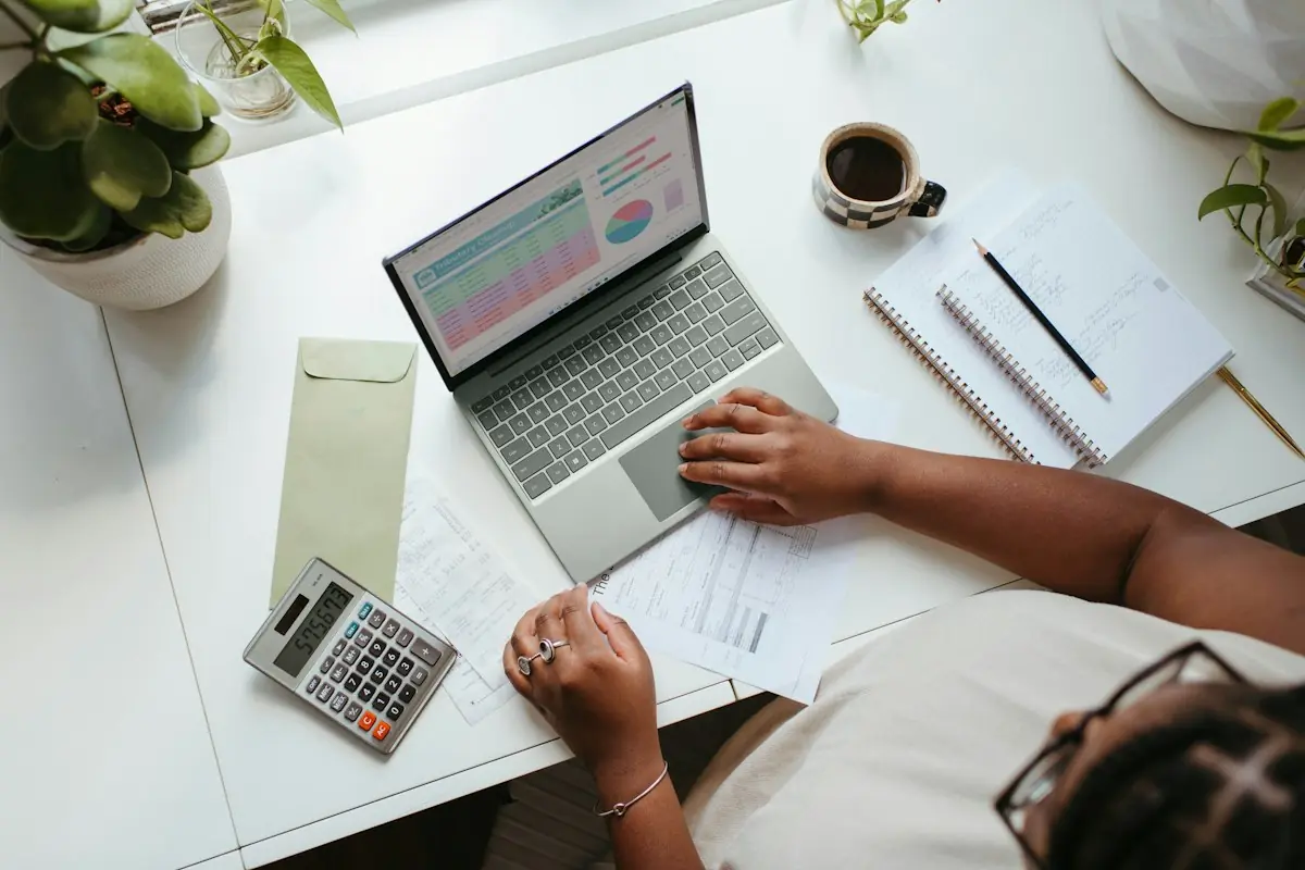 Small business owner reviewing payment processing costs on a laptop